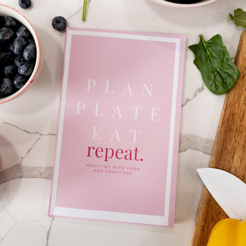 Mindset Nutrition's Plan Plate Eat Repeat food journal surrounded by whole foods