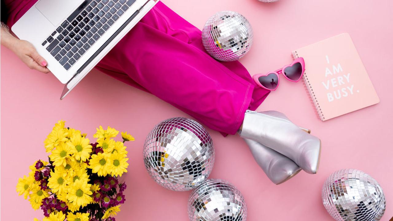 Erin working on Mindset Nutrition laptop, surrounded by flowers and mirror balls